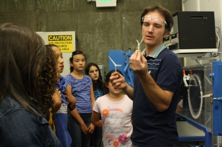 Alex Jordan, Senior Lab Mechanician at UC Berkeley's Hesse Hall, demonstrates how propellers printed from a 3-D printer can be tested using the wind tunnel behind him.